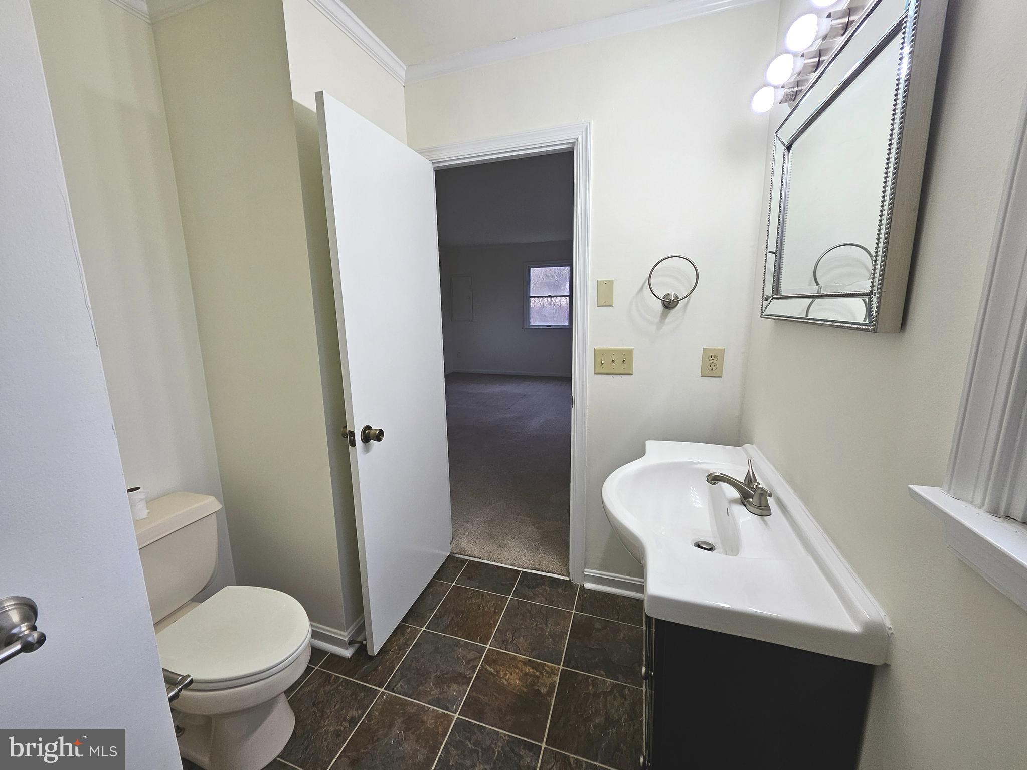 873 Skeeter Neck Road Frederica, DE 19946 - Photo 20 of 34 a bathroom with a sink toilet and shower