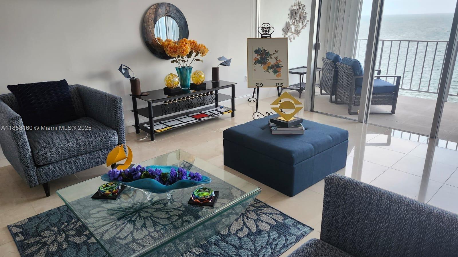 881 Ocean Drive, Unit 16F Key Biscayne, FL 33149 - Photo 3 of 6 a living room with furniture chess board and a chandelier