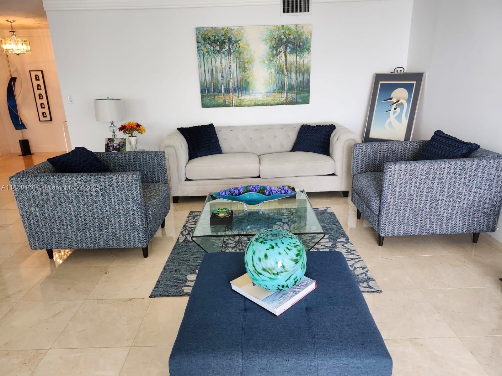 881 Ocean Drive, Unit 16F Key Biscayne, FL 33149 - Photo 4 of 6 a living room with furniture and a rug