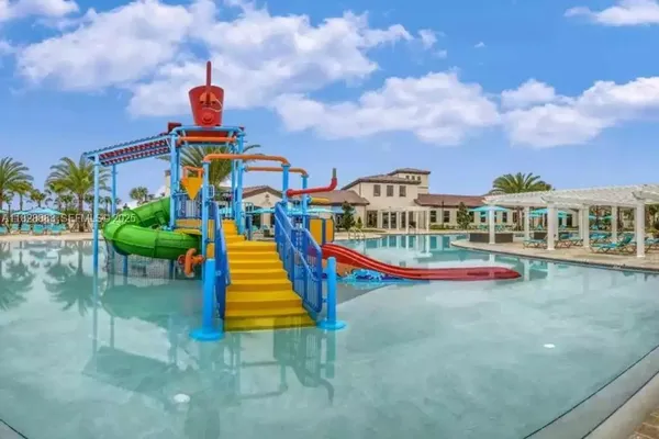 a front view of a house with swimming pool and seating