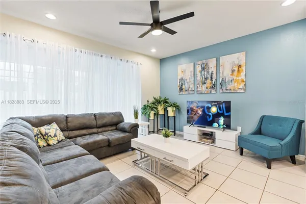 a living room with furniture and painting on the wall