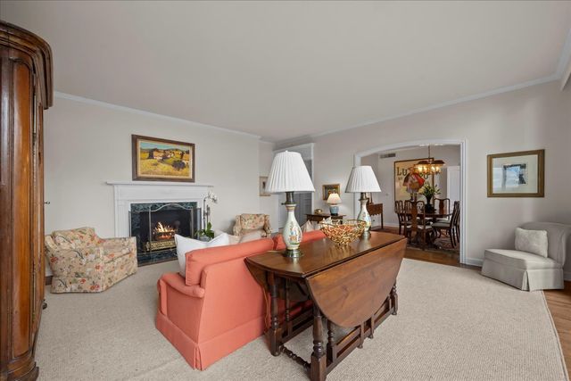 a view of a dining room with furniture wooden floor and a chandelier