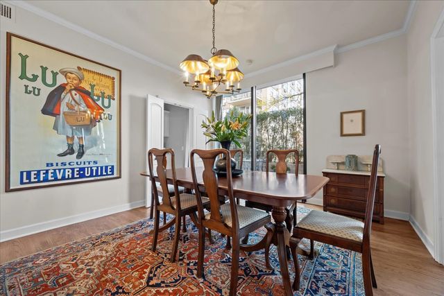 a view of a dining room with furniture wooden floor and a chandelier