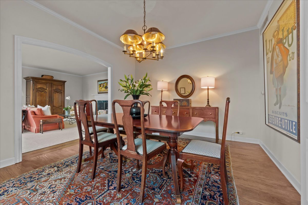 1420 Sheridan Road, Unit 1H Wilmette, IL 60091 - Photo 14 of 40 a view of a dining room with furniture wooden floor and a chandelier