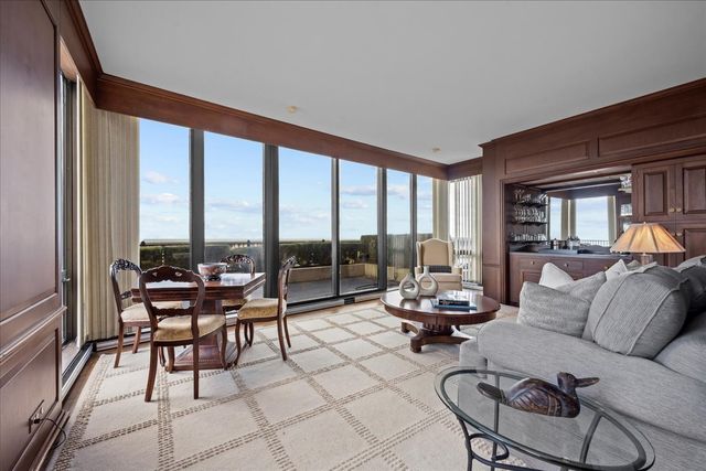 a living room with furniture and a floor to ceiling window