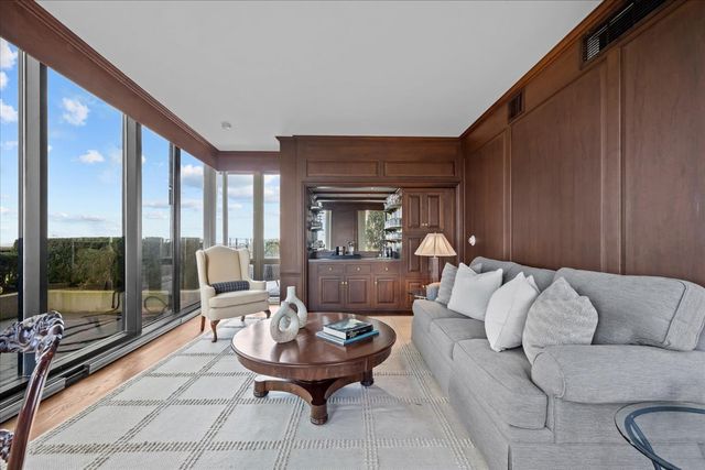 a living room with furniture and a floor to ceiling window