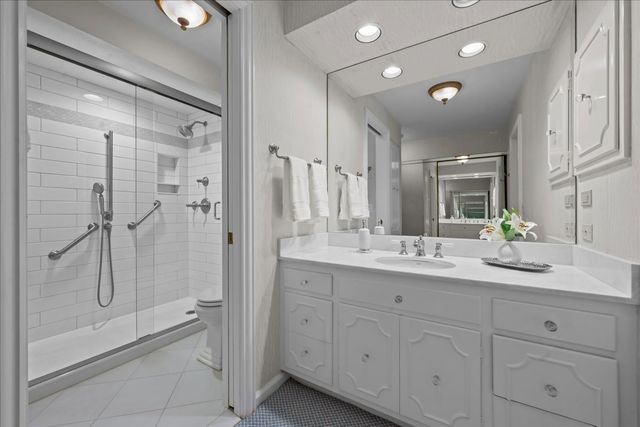 a bedroom with a bed and a flat tv screen on dresser