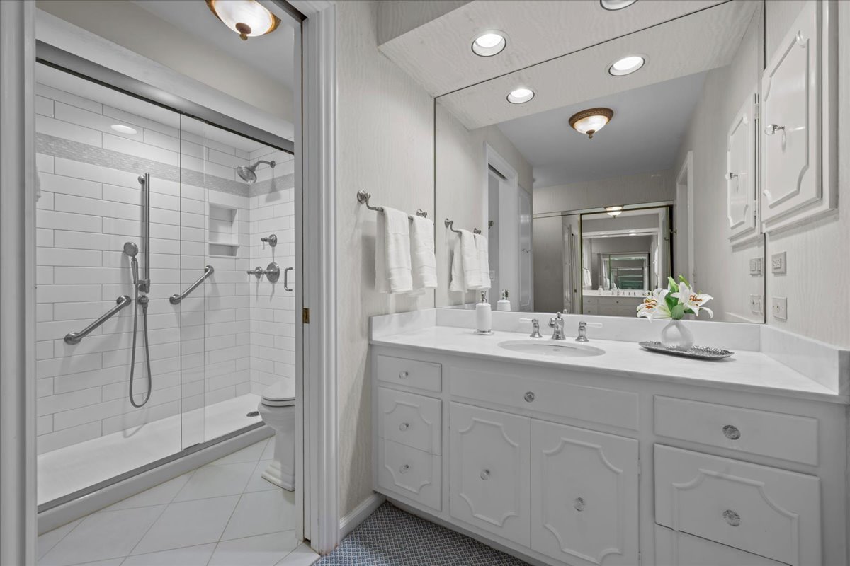 1420 Sheridan Road, Unit 1H Wilmette, IL 60091 - Photo 24 of 40 a bathroom with a granite countertop sink mirror and shower