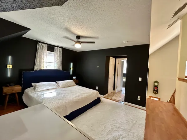 a bedroom with a bed and a chandelier