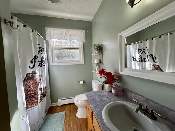 a bedroom with a bed closet and a flat tv screen