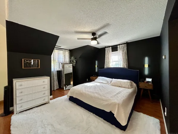 a room with a bed and a mirror
