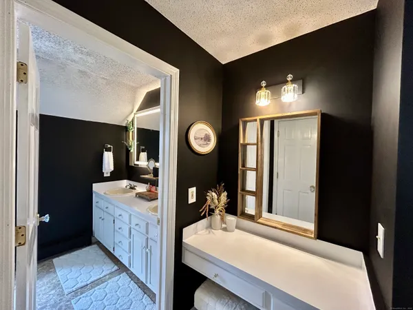 a bathroom with a double vanity sink and a mirror