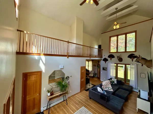 a living room with furniture and wooden floor