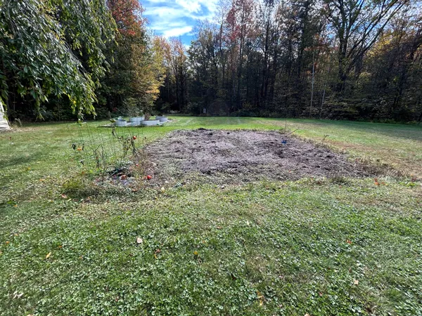 a view of a white house with a yard
