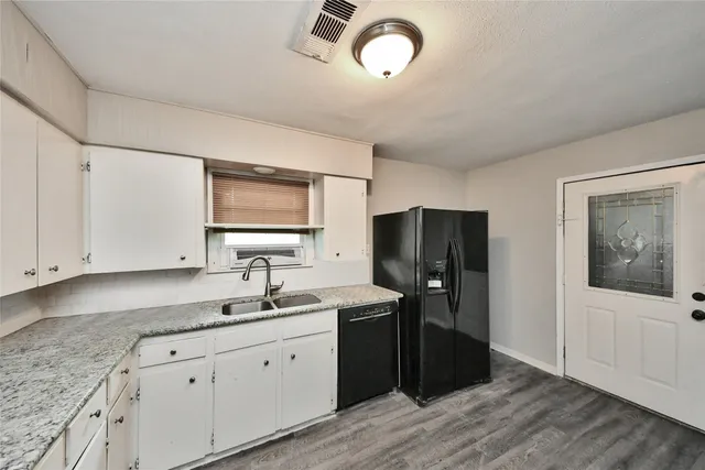 a kitchen with a sink and refrigerator