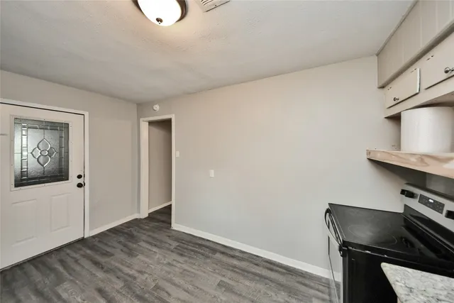 a view of workspace with wooden floor cabinet and bathroom