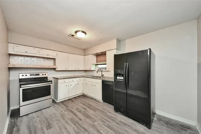 a kitchen with a refrigerator stove and sink