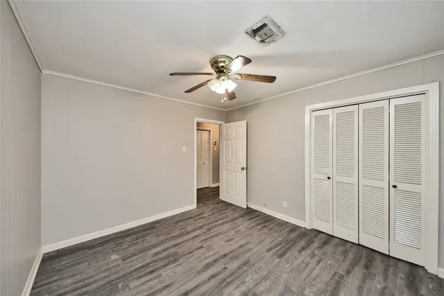 a view of a room with a ceiling fan a ceiling fan and a window