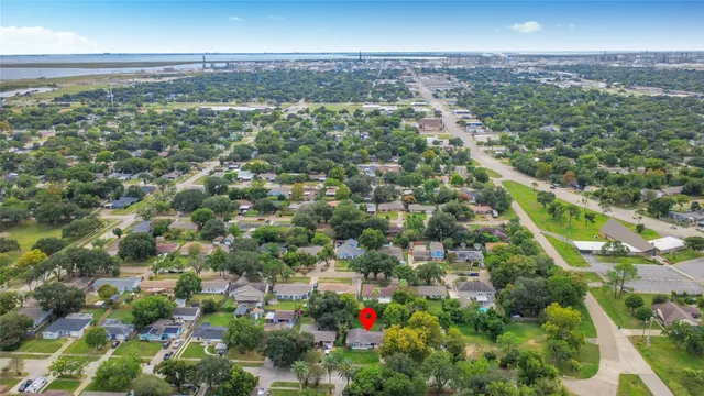 an aerial view of residential houses with city view