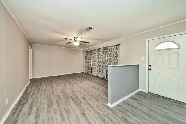 wooden floor in an empty room with a window