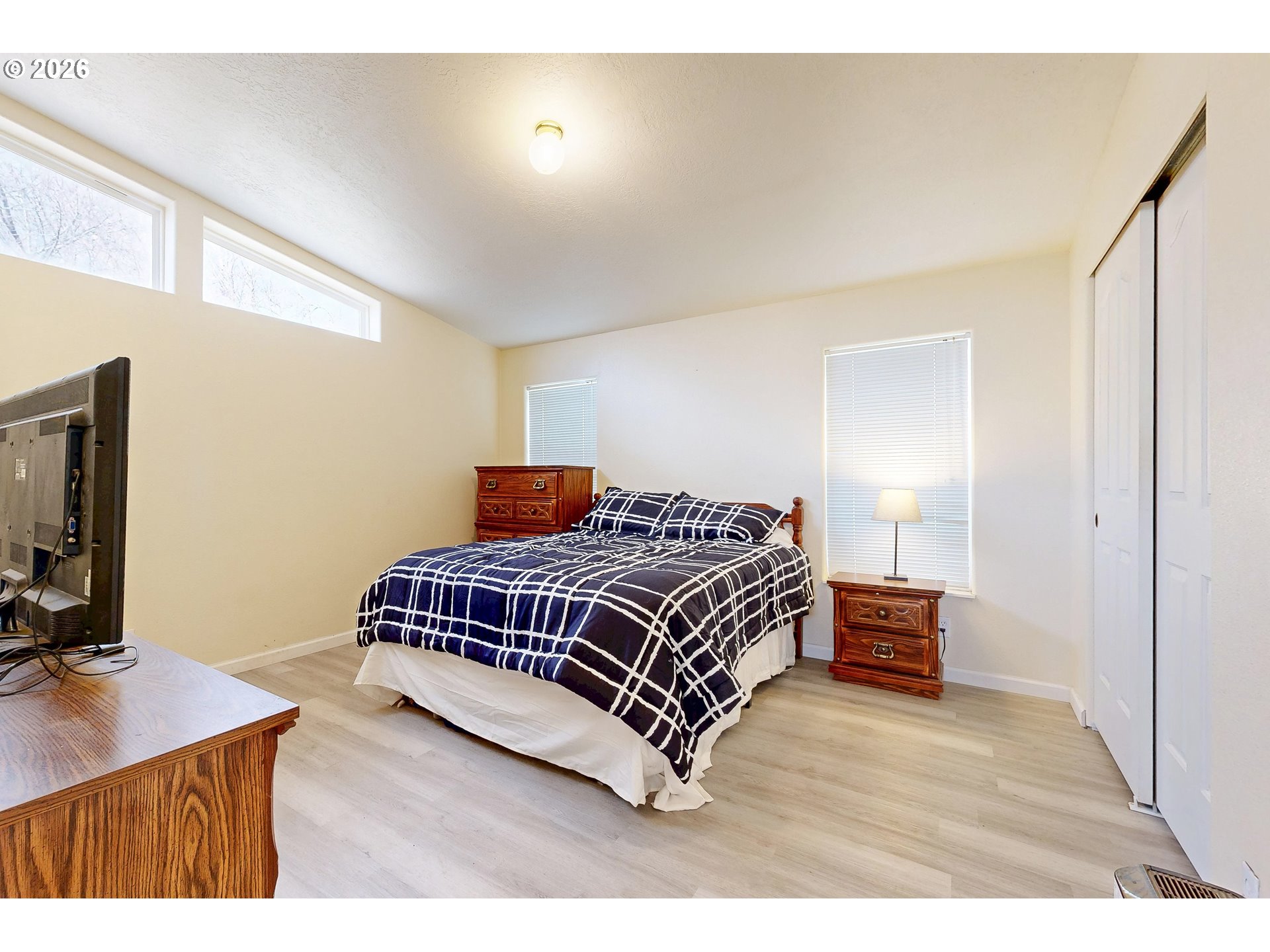 84889 Triangle Station Road Milton Freewater, OR 97862 - Photo 24 of 40 a bedroom with a bed and a flat screen tv
