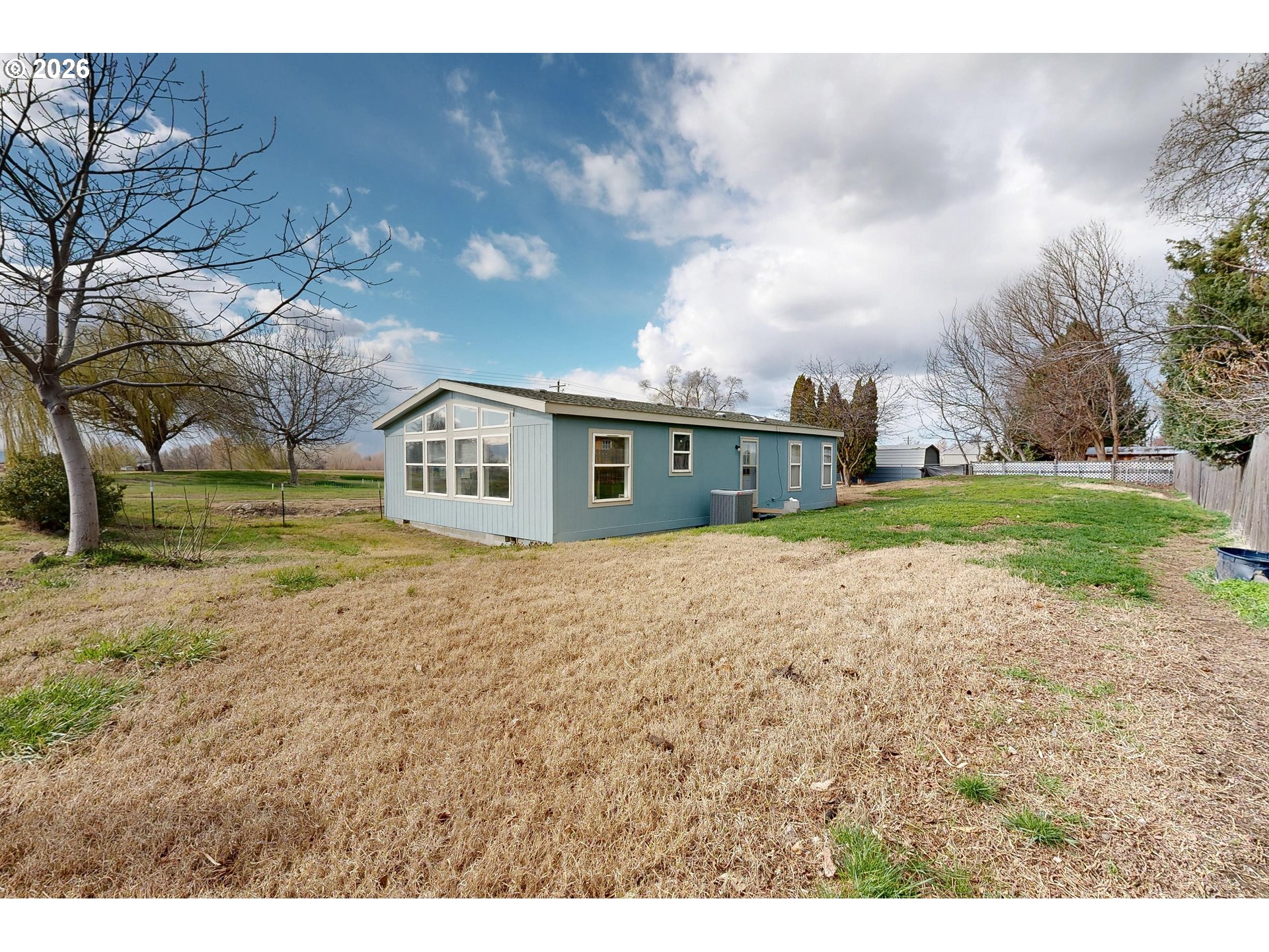 84889 Triangle Station Road Milton Freewater, OR 97862 - Photo 30 of 40 a big house with a big yard and large trees