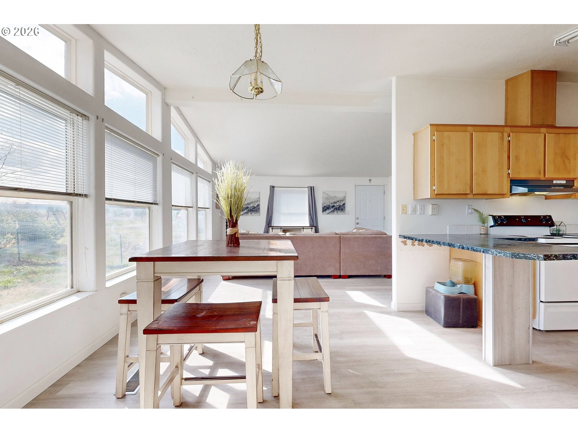 84889 Triangle Station Road Milton Freewater, OR 97862 - Photo 6 of 40 a living room with a table and chairs with wooden floor