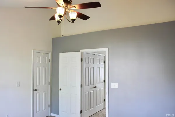 a view of a chandelier fan and closet