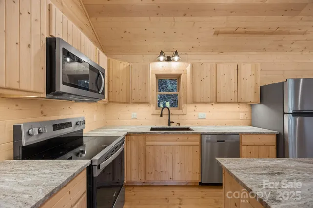a kitchen with a sink stove and microwave