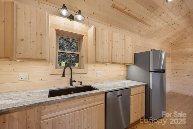 a kitchen with a sink cabinets and stainless steel appliances