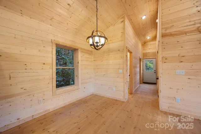 a view of a hallway with wooden floor and entryway