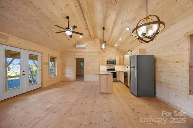 a view of a kitchen with furniture and a ceiling fan