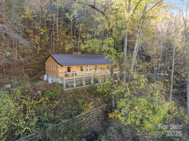 a view of a balcony with plants and brick wall