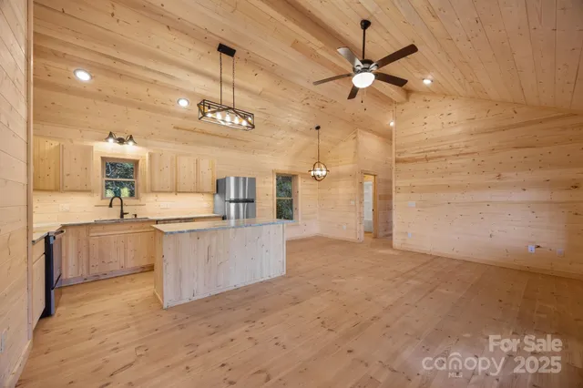 a view of kitchen with sink and refrigerator