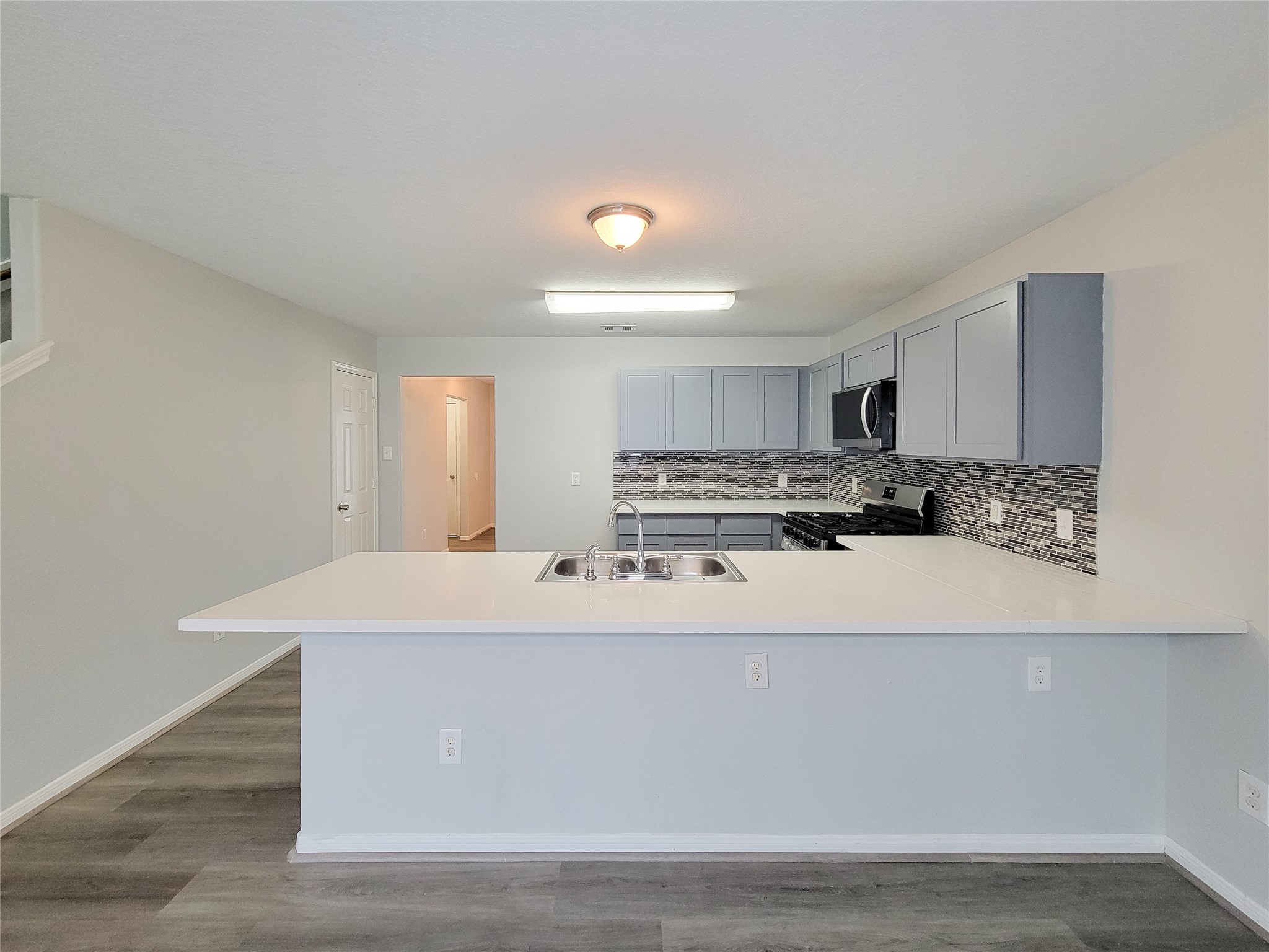 3602 Zephyr Glen Way Houston, TX 77084 - Photo 13 of 42 a large white kitchen with wooden floor