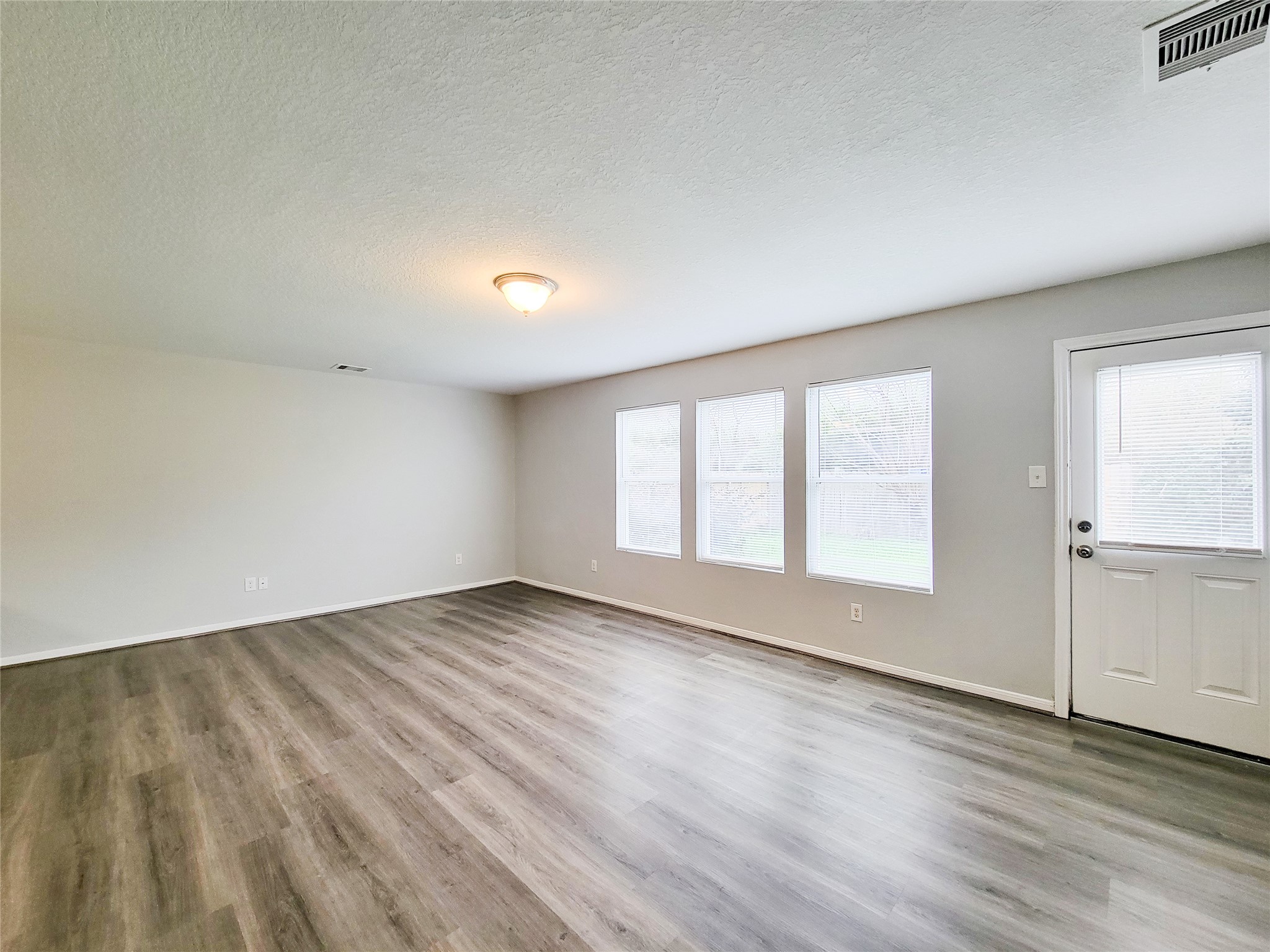 3602 Zephyr Glen Way Houston, TX 77084 - Photo 17 of 42 an empty room with wooden floor and windows