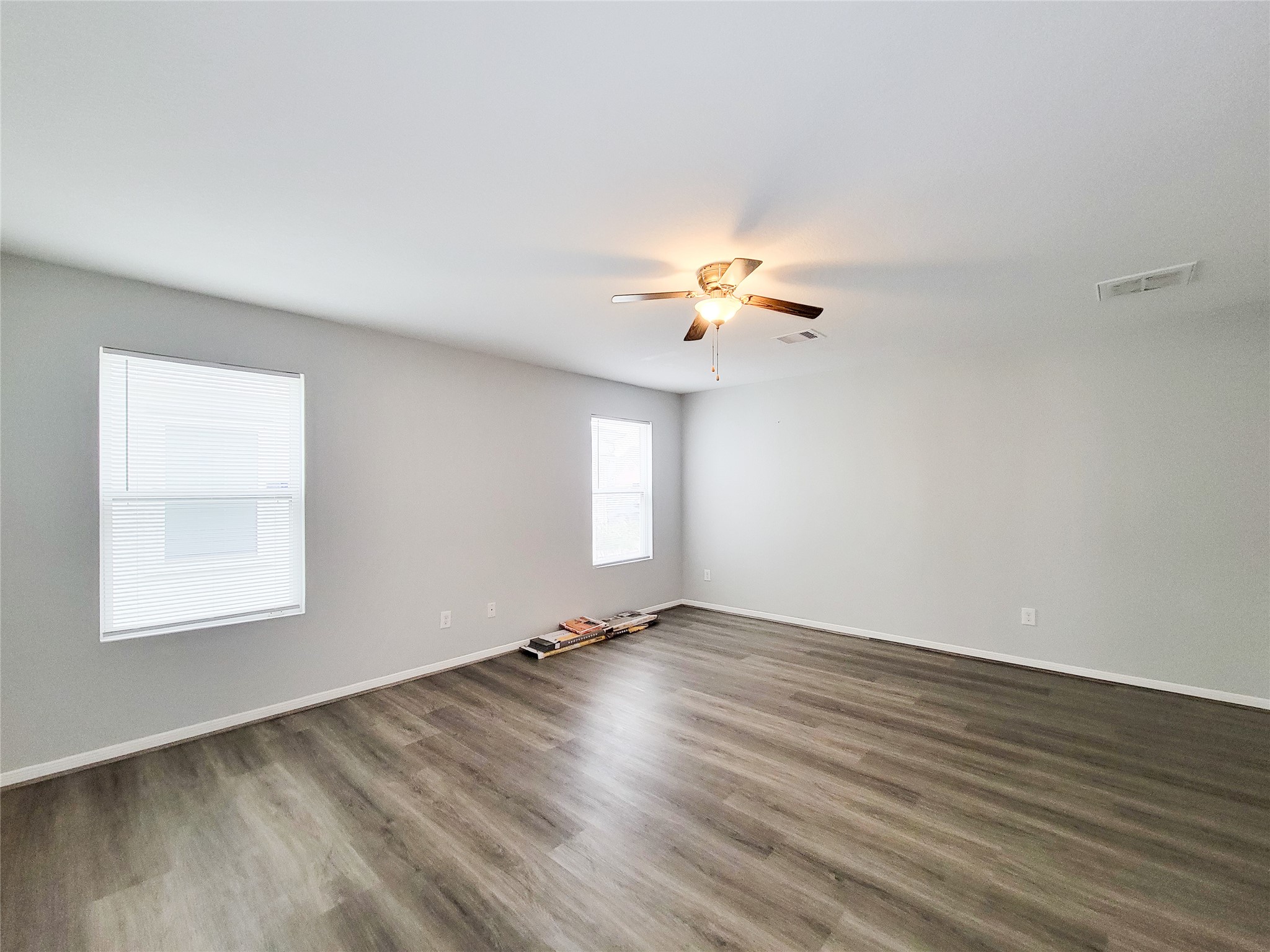 3602 Zephyr Glen Way Houston, TX 77084 - Photo 19 of 42 an empty room with wooden floor chandelier fan and windows