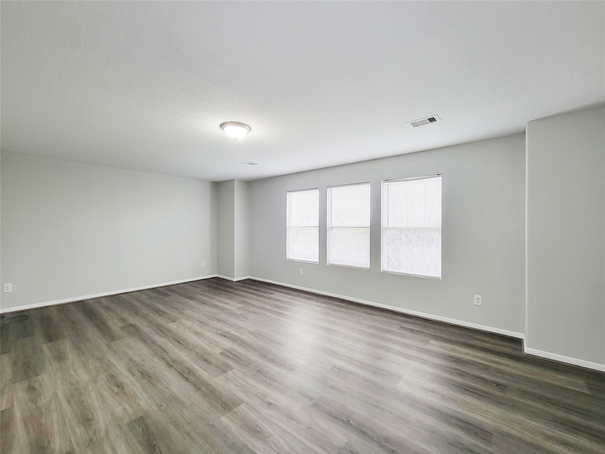 3602 Zephyr Glen Way Houston, TX 77084 - Photo 26 of 42 an empty room with wooden floor and windows
