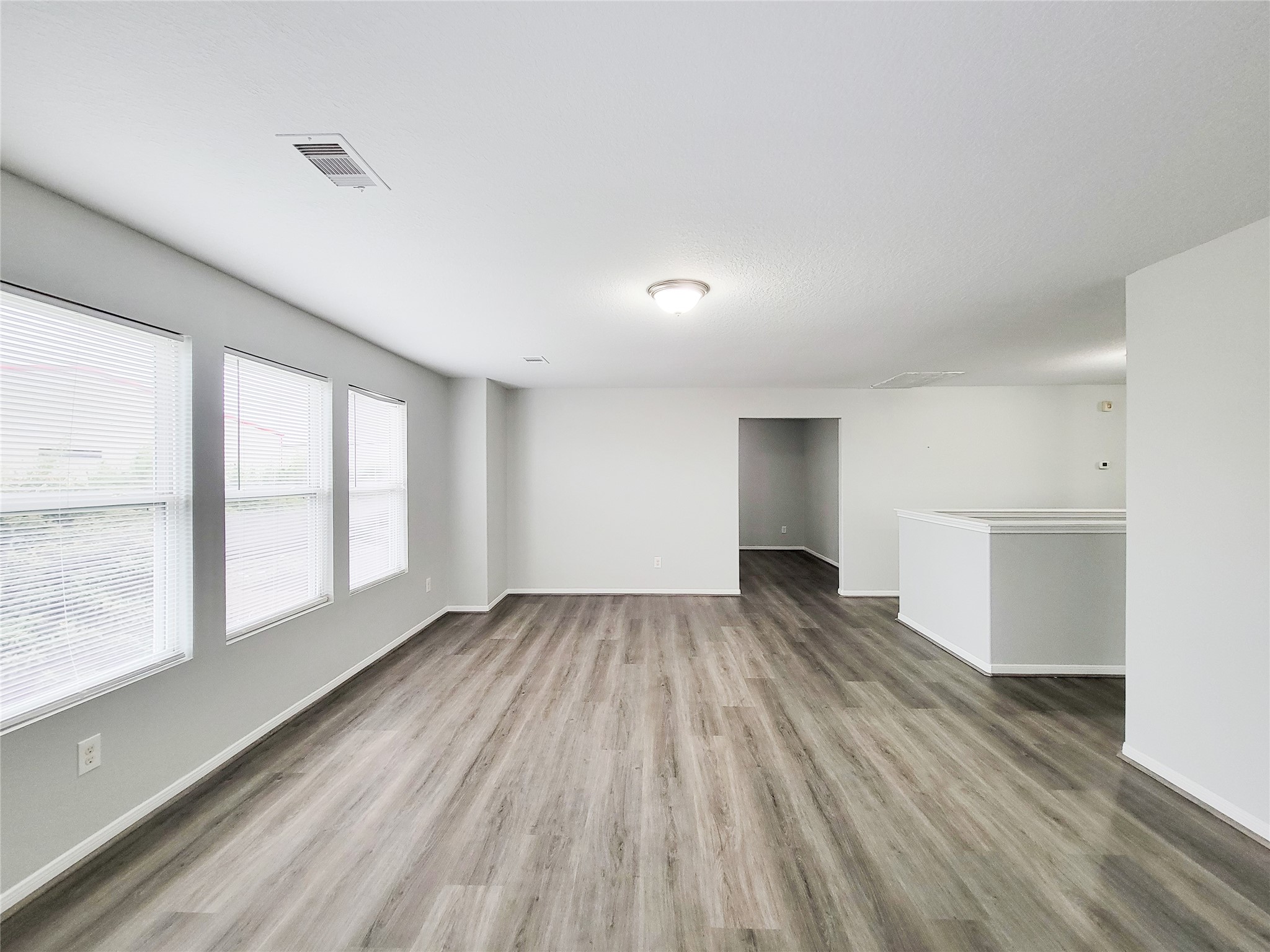 3602 Zephyr Glen Way Houston, TX 77084 - Photo 28 of 42 a view of an empty room with wooden floor and a window