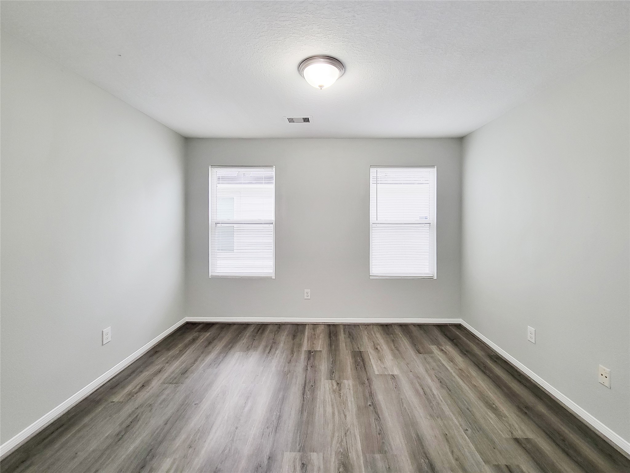 3602 Zephyr Glen Way Houston, TX 77084 - Photo 32 of 42 an empty room with wooden floor and windows