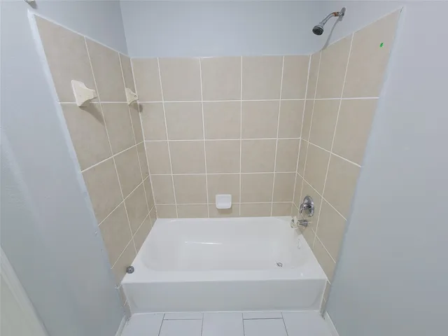 a bath tub sitting next to a white sink