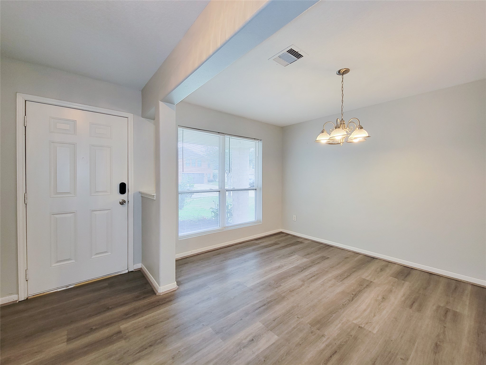 3602 Zephyr Glen Way Houston, TX 77084 - Photo 4 of 42 wooden floor in an empty room with a window