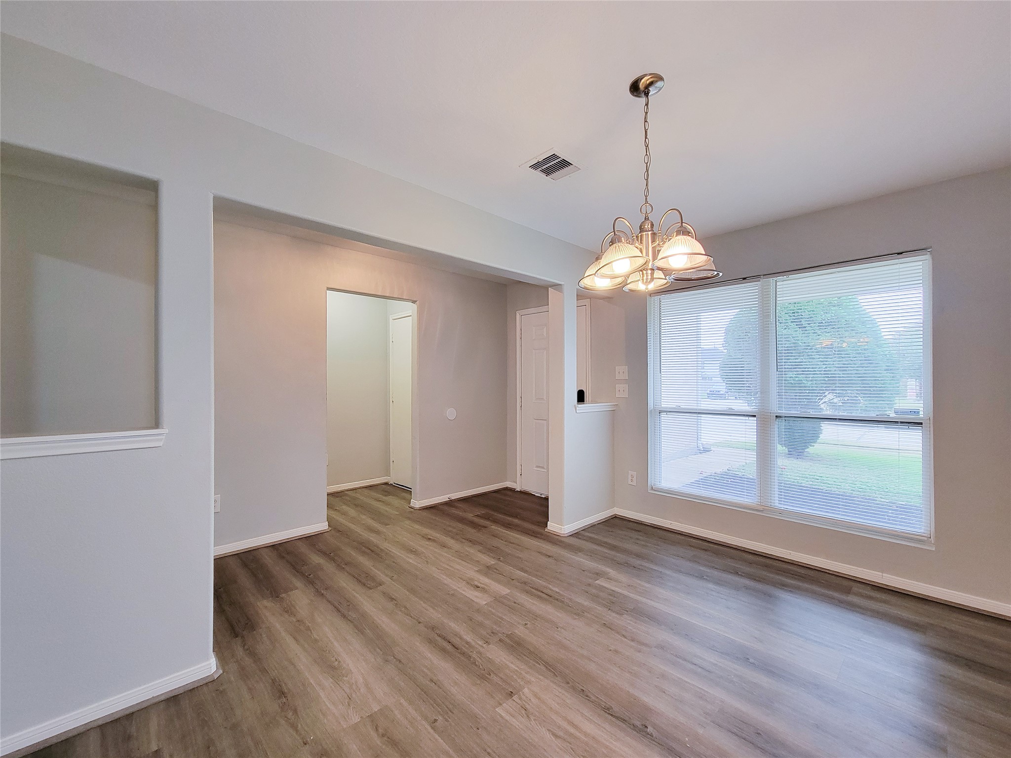 3602 Zephyr Glen Way Houston, TX 77084 - Photo 5 of 42 an empty room with wooden floor and windows