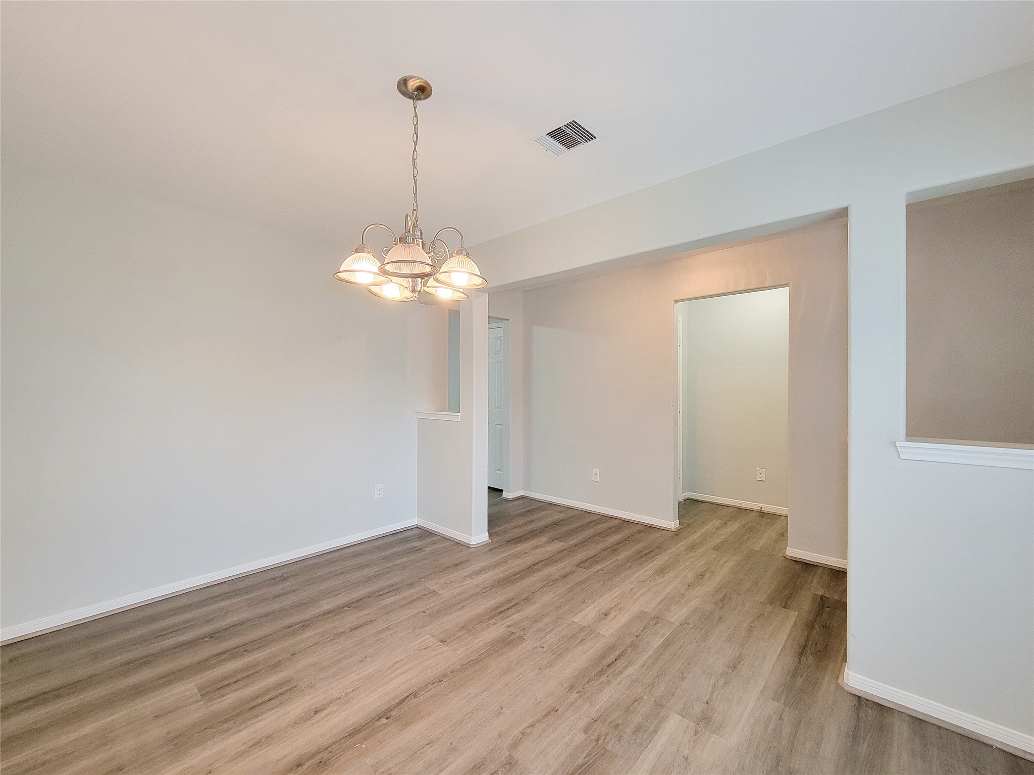 3602 Zephyr Glen Way Houston, TX 77084 - Photo 6 of 42 a view of a room with wooden floor chandelier and entryway