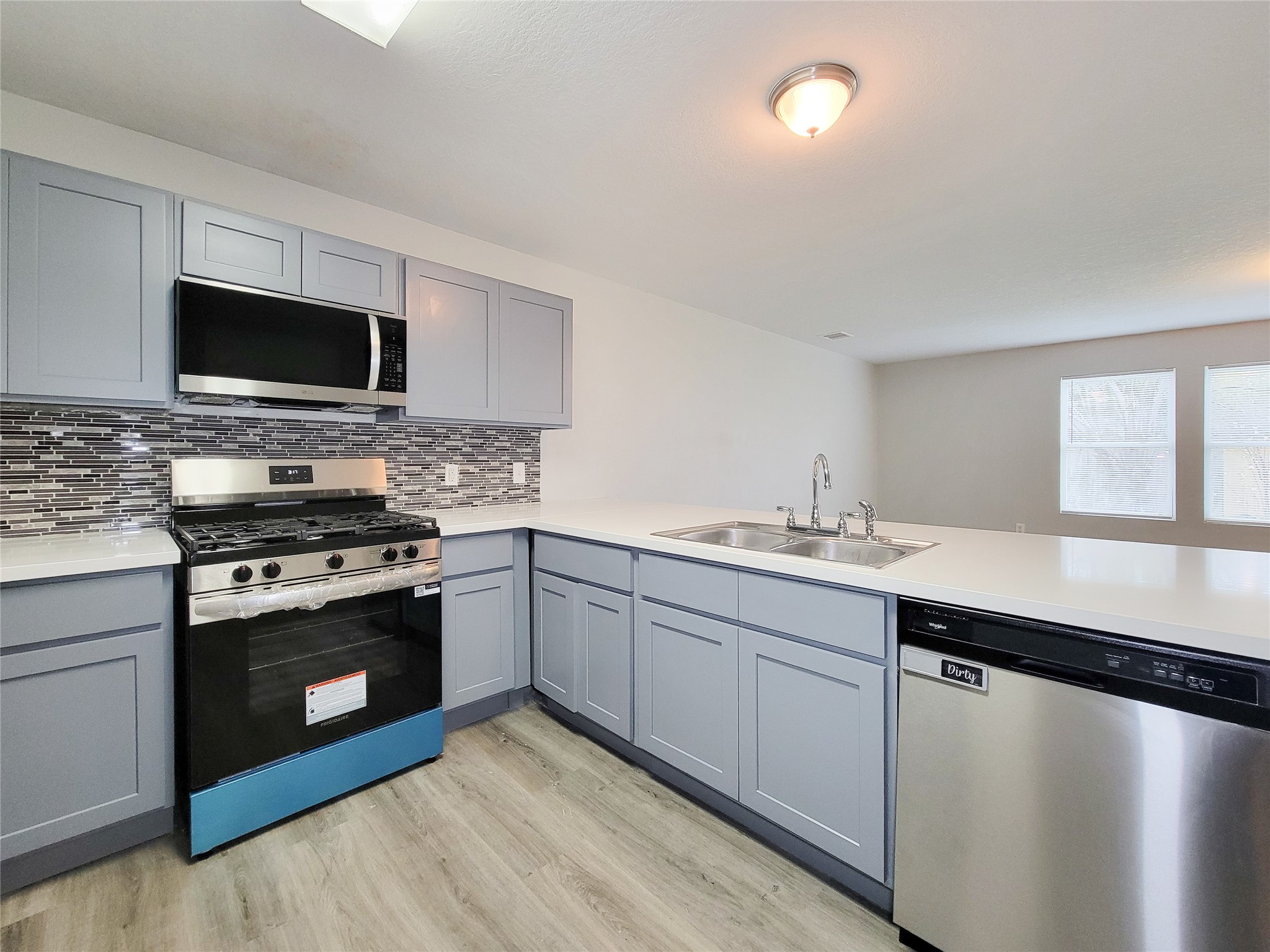 3602 Zephyr Glen Way Houston, TX 77084 - Photo 10 of 42 a kitchen with stainless steel appliances granite countertop a stove top oven a sink and a microwave