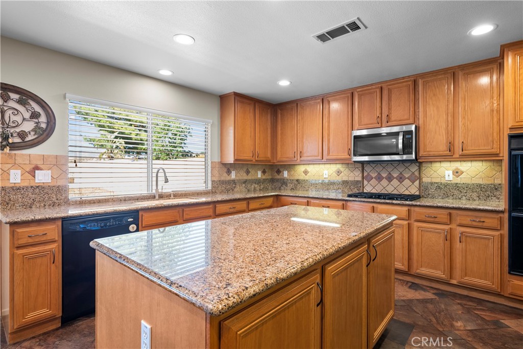 32810 The Old Road Castaic, CA 91384 - Photo 19 of 45 a kitchen with stainless steel appliances granite countertop a sink stove and cabinets