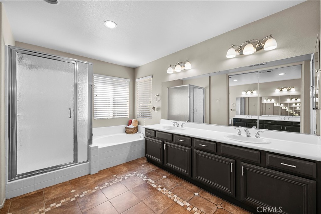 32810 The Old Road Castaic, CA 91384 - Photo 25 of 45 a spacious bathroom with a double vanity sink a mirror and a bathtub