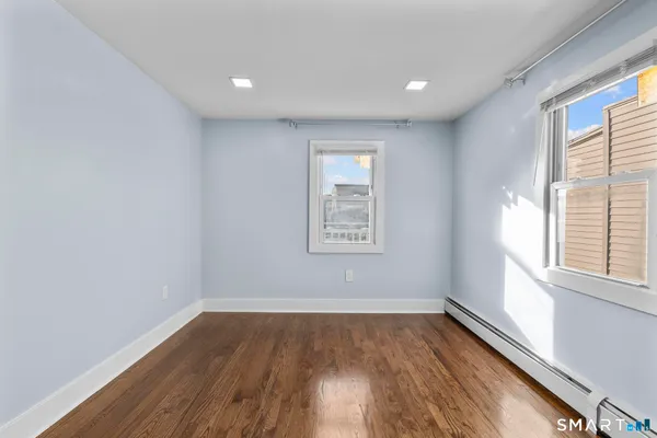 a view of a room with wooden floor and window