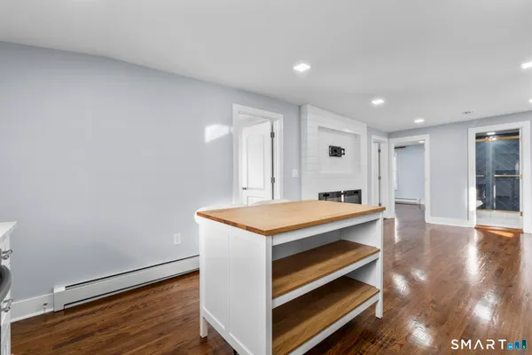 a room with wooden floor and ceiling fan