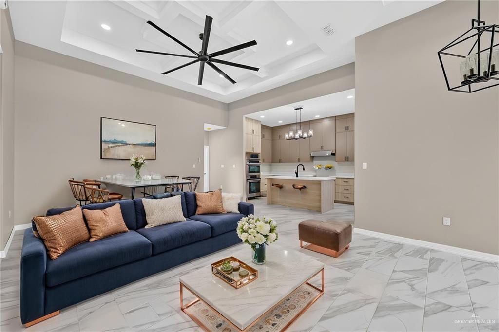 1920 Trinity Street Donna, TX 78537 - Photo 5 of 23 Expansive living area with a coffered ceiling and a contemporary ceiling fan